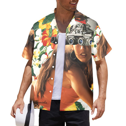 A man wearing a multicolored Hawaiian shirt with a vibrant floral and eye graphic design, and a white hat.